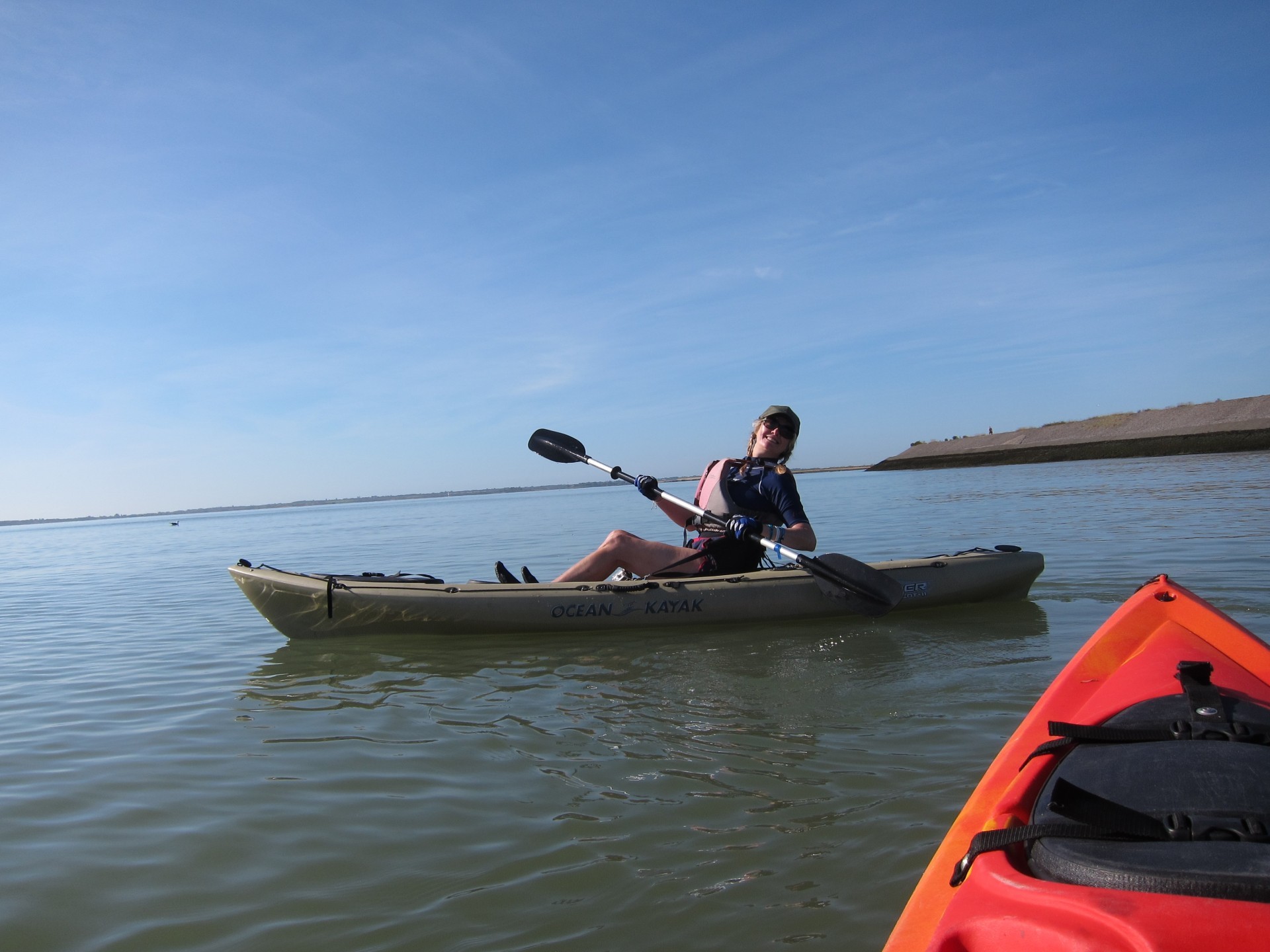 Woman on a sit-on-top kayak enjoying a guided trip