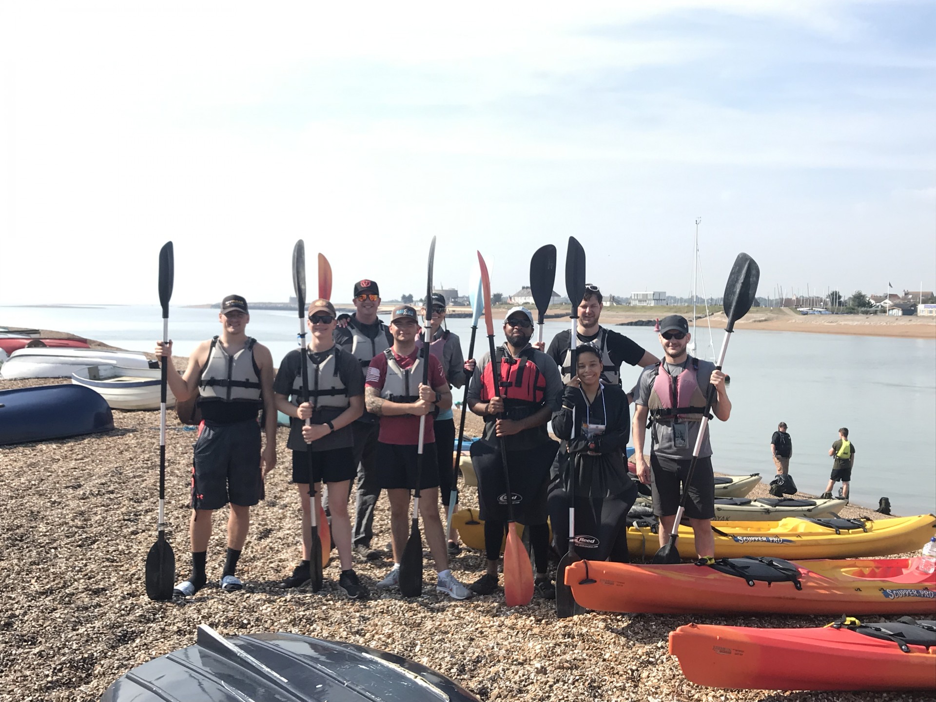RAF Mildenhall group photo on the beach with NOMAD Sea Kayaking.
