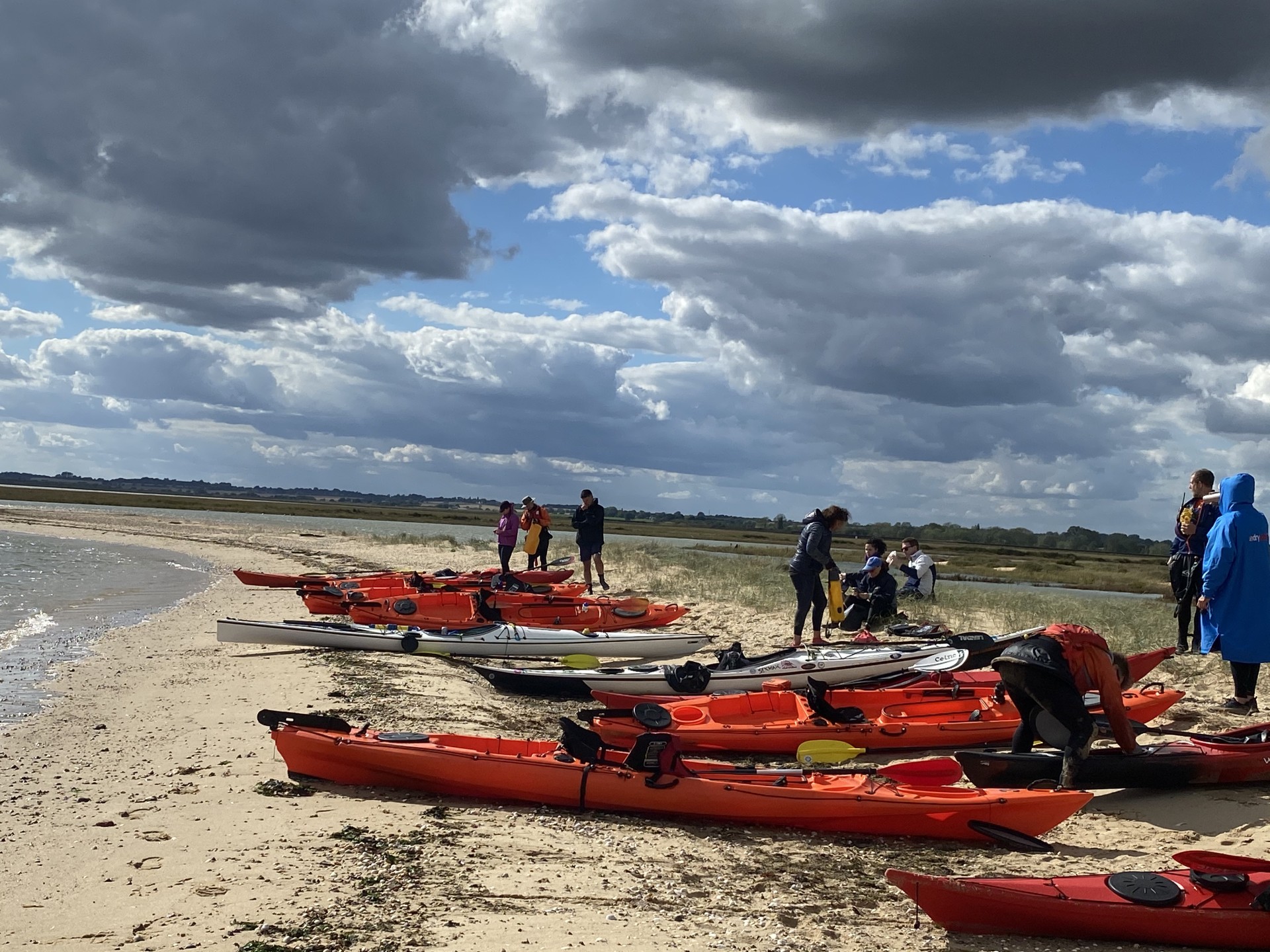 Sea kjayalks landed on a sandy beach on the Seal Colony Eco kayak tour with NOMAD Sea Kayaking.