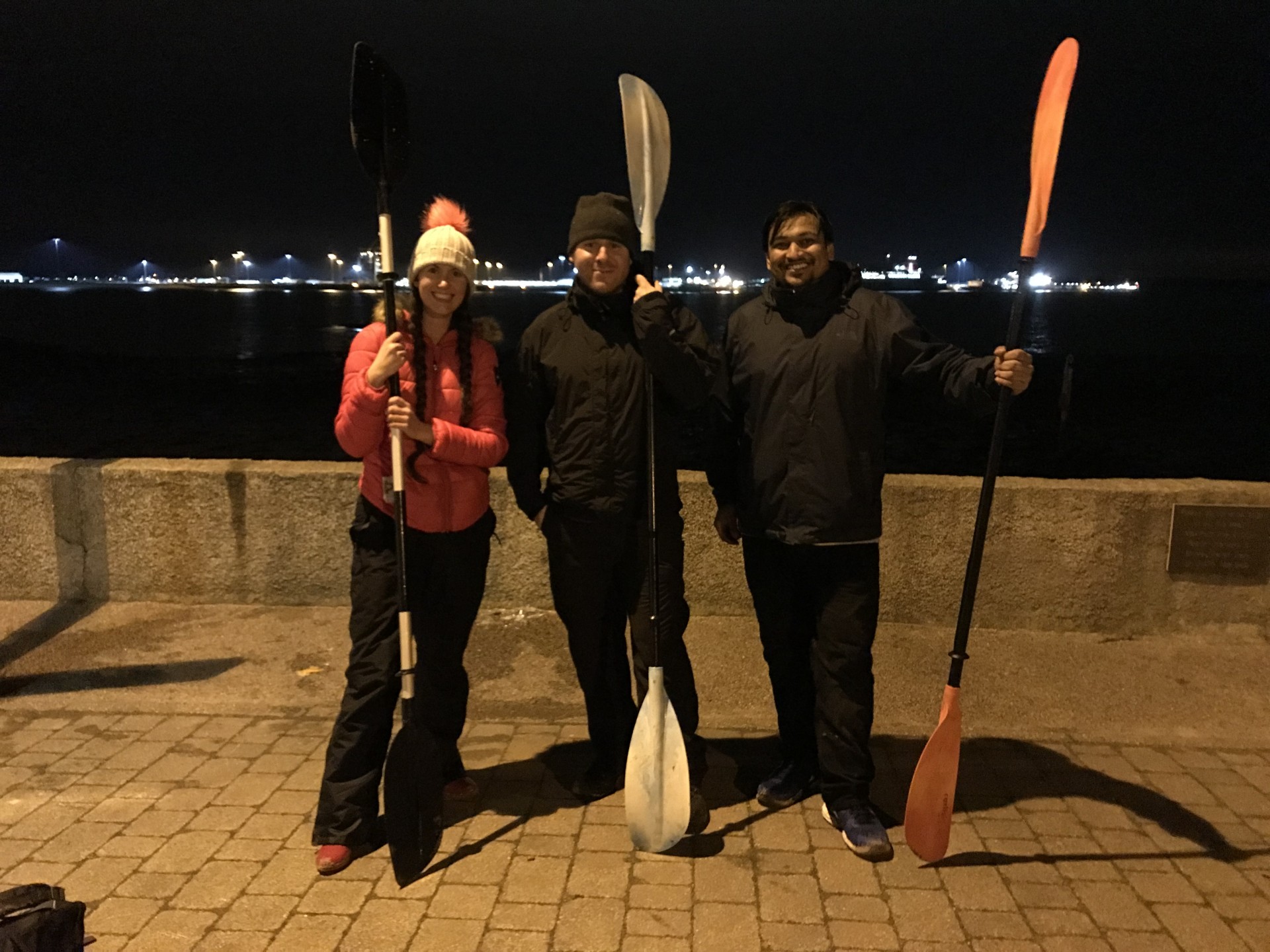 Three guests with paddles posing before the Harwich harbour fireworks display