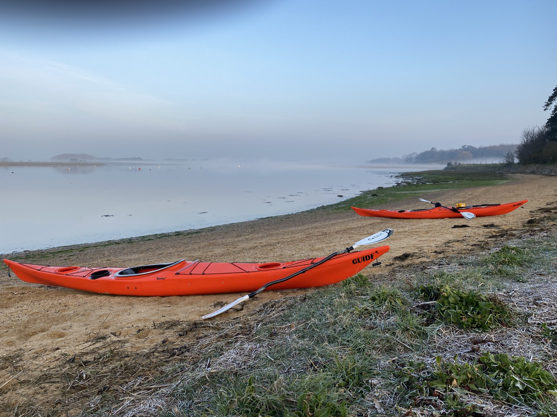 Two orange sea kayaks on the beach at Ramsholt.