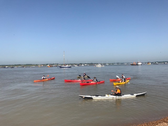 Sea kayaks on the water with NOMAD Sea Kayaking.