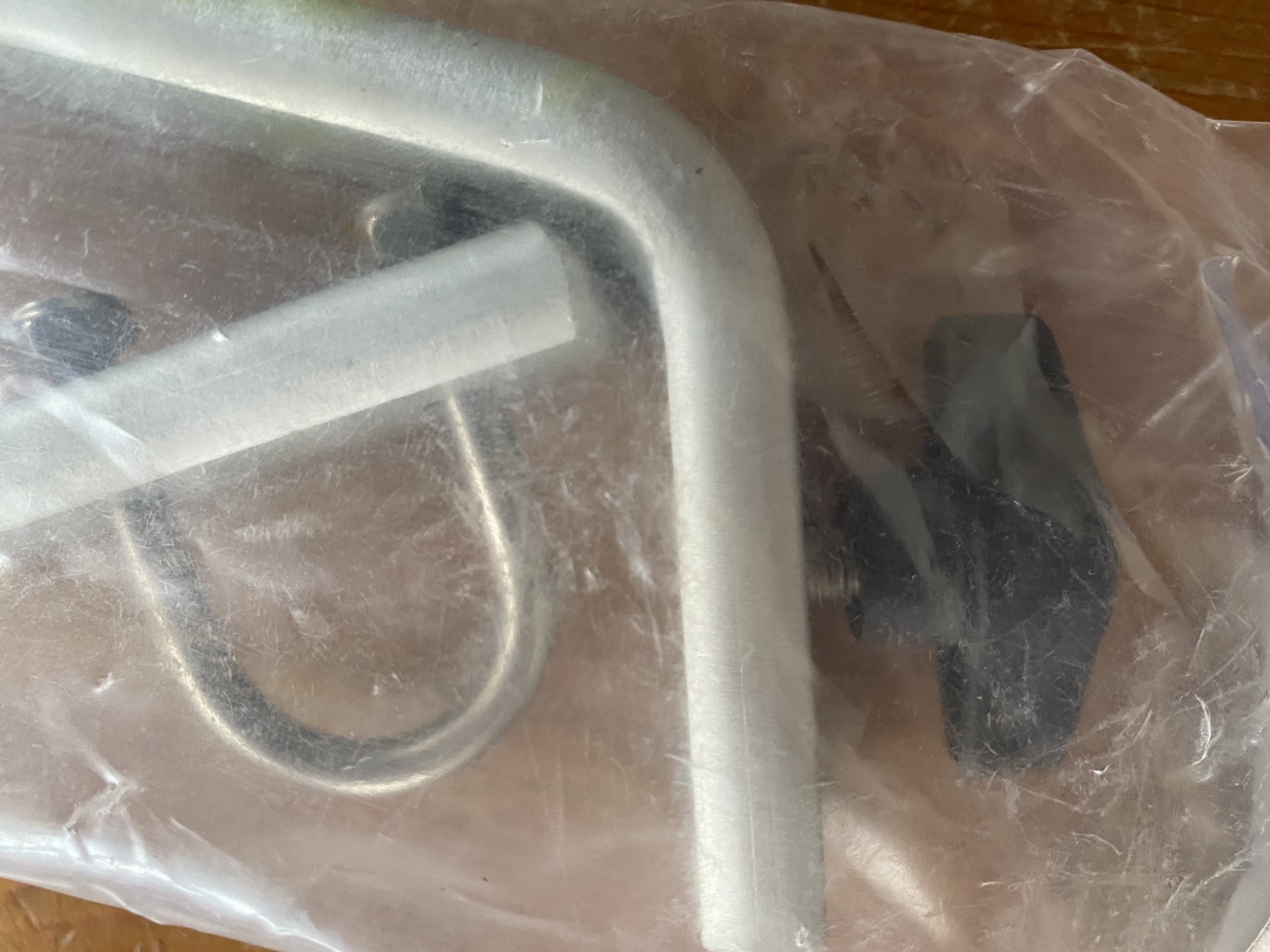 Contents of bag shows handle with bracket and finger tightener