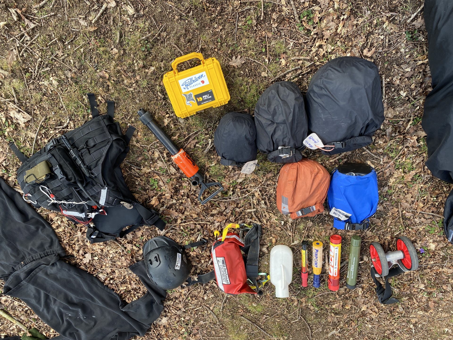 Sea kayaking equipment laid out, including emergency flares.