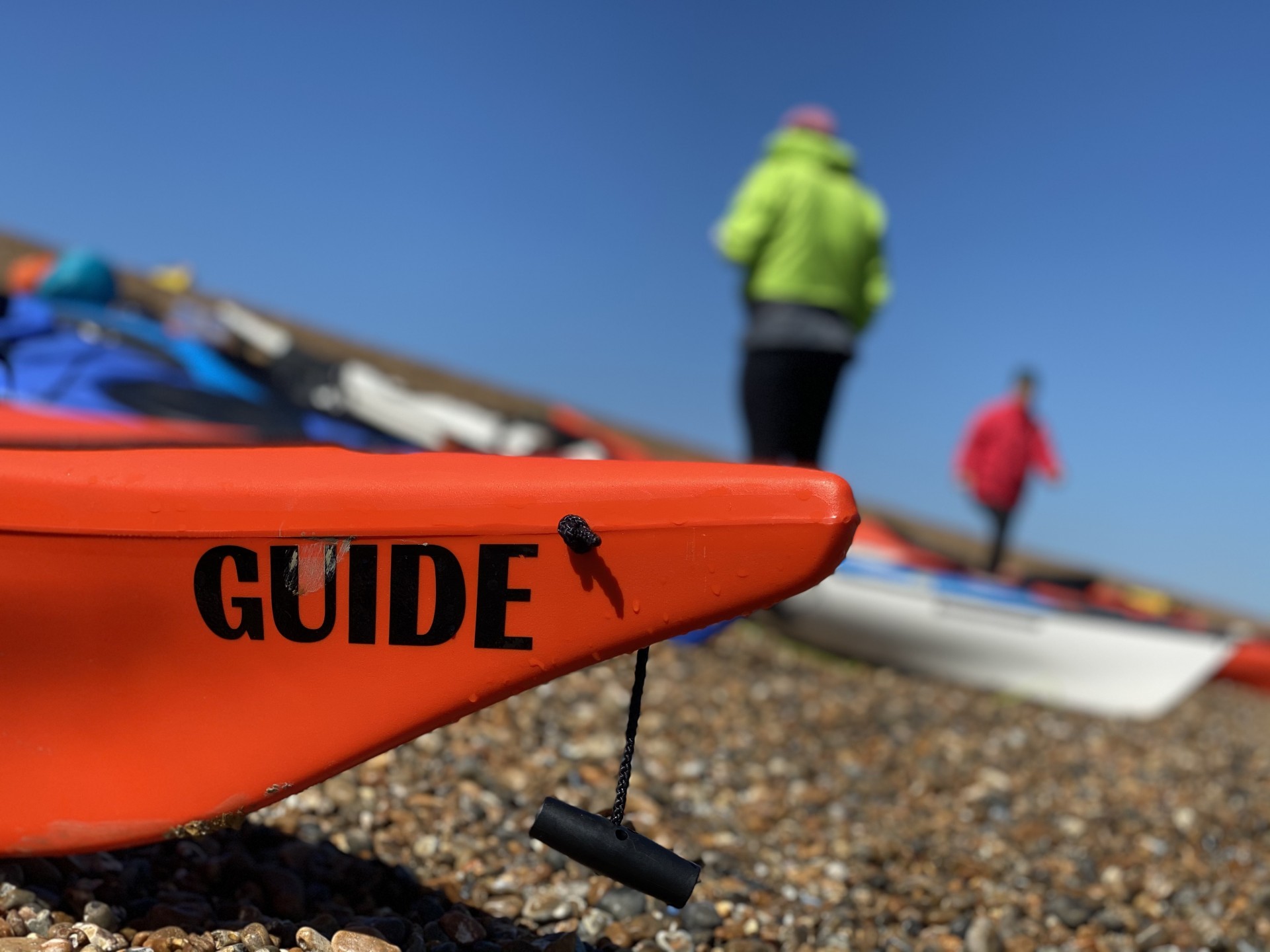 The front of the sea kayak with the the word 'Guide' printed on the bow.