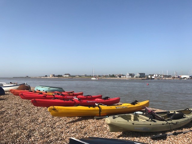 Bawdsey Quay launch venue with sea kayaks on the shingle beach for the wild camping weekend.