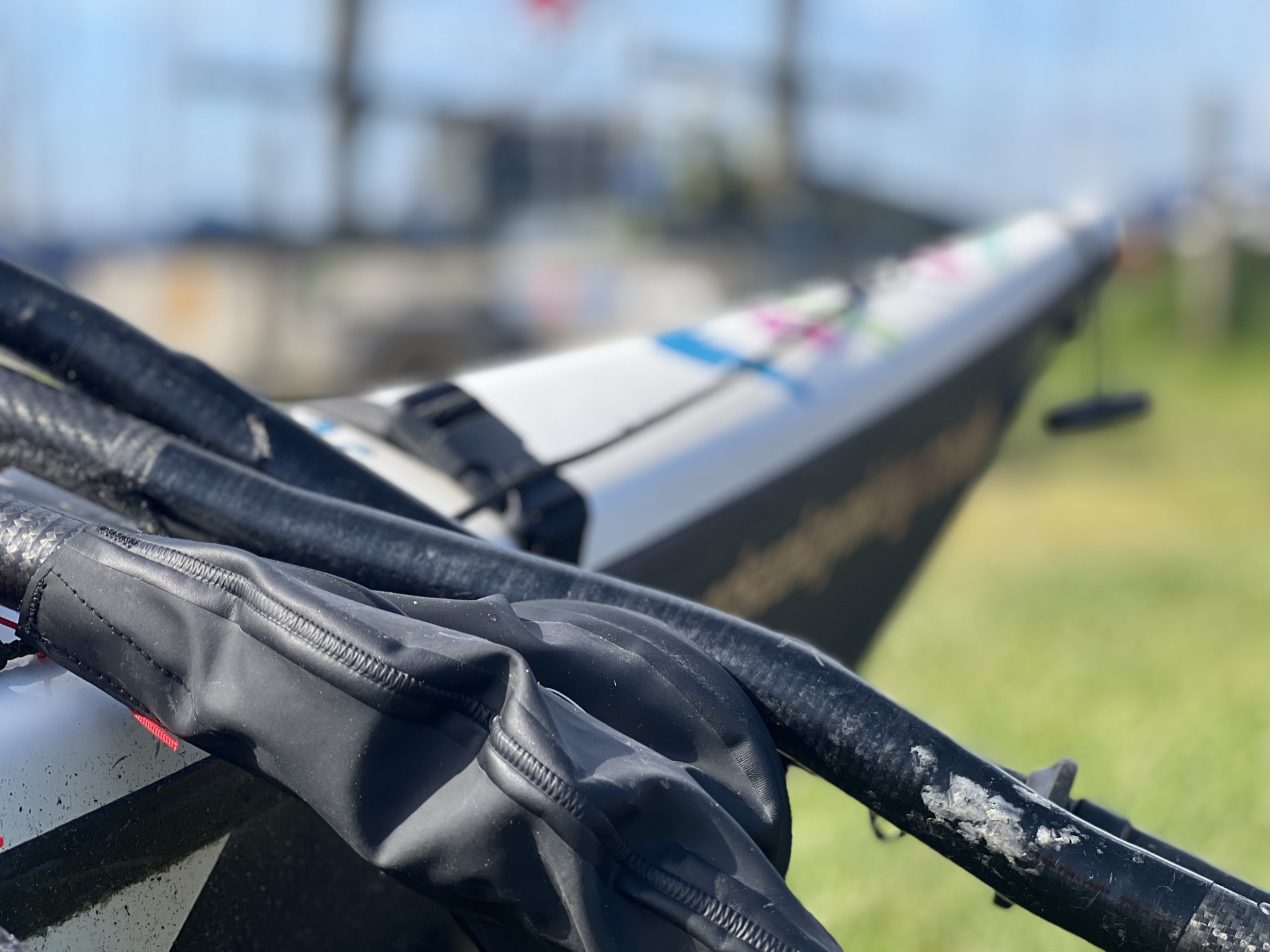 Black paddle shaft against a white sea kayak.