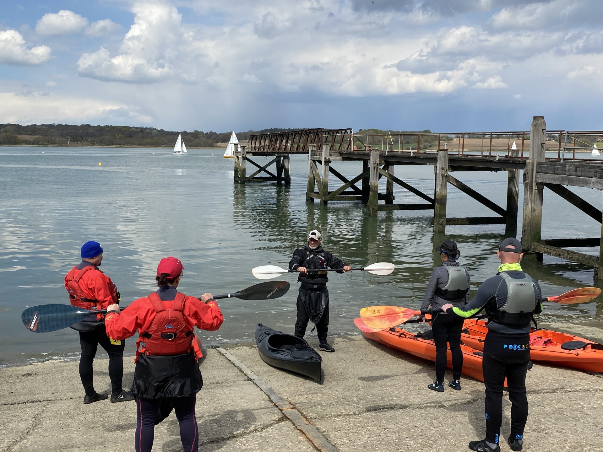 Tutoring students on paddle technique pin the Introduction to Kayaking course in Suffolk.