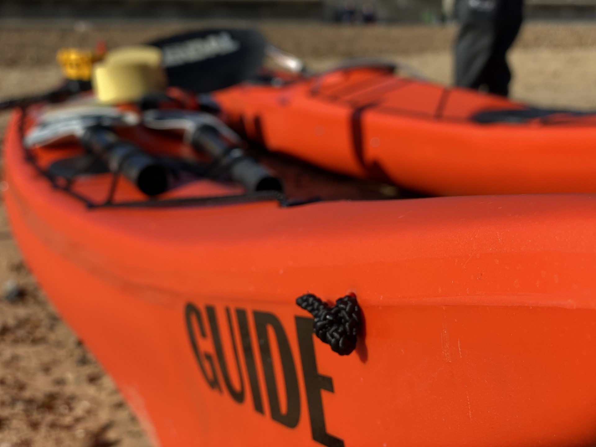 A sea kayak clearly showing the word 'Guide' on the bow.