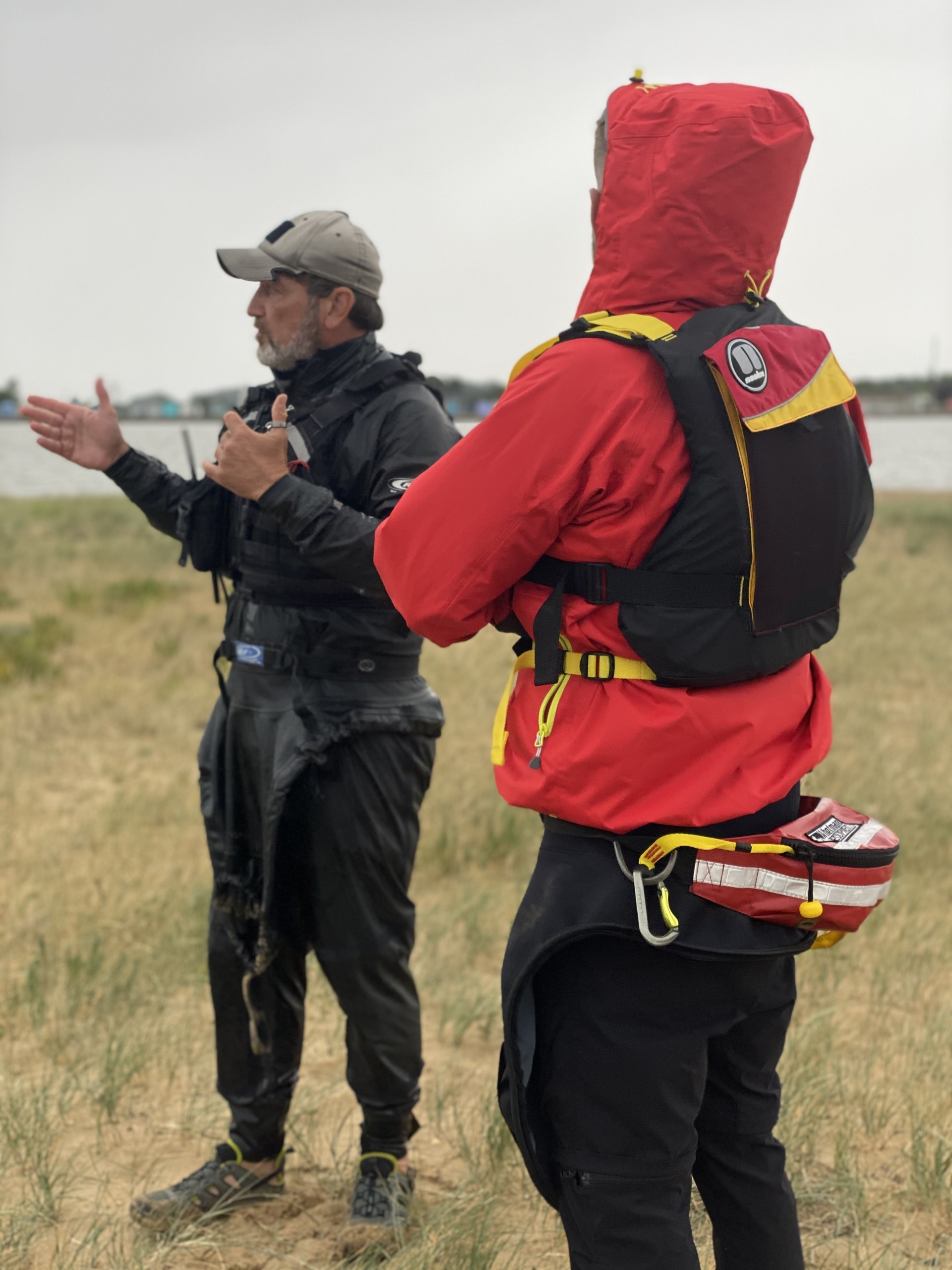 A small group with their coach being trained on the Introduction to Sea Kayaking course