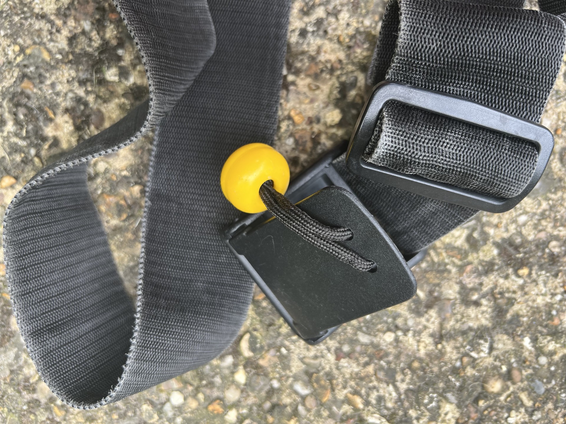 Quick release buckle with a yellow toggle sold at NOMAD Sea Kayaking.