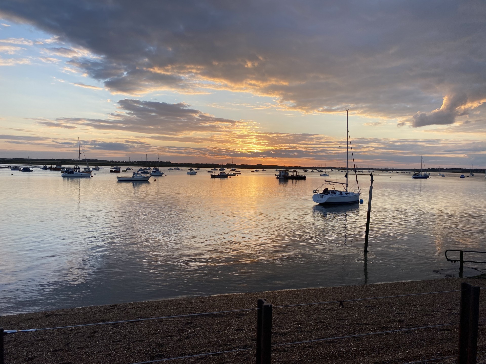 Suffolk sunset sky with yachts moored in the distance