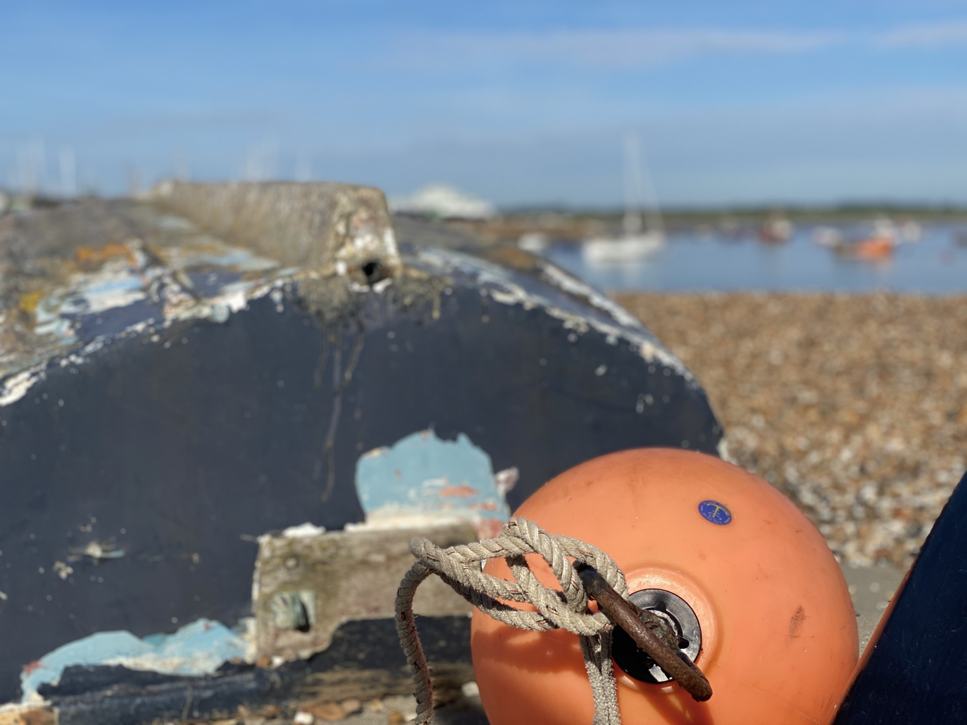 A buoy alongside a dinghy on a Suffolk beach with NOMAD Sea Kayaking.