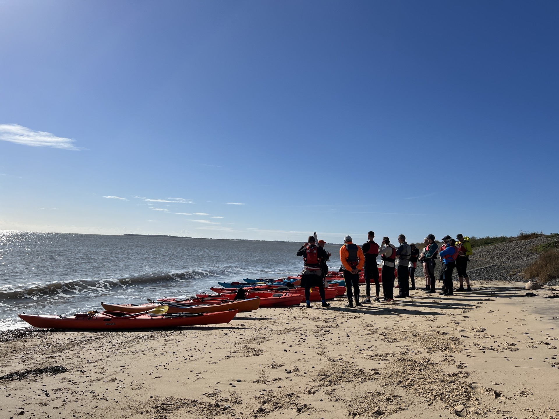 Preparing to launch kayaks with blue skies overhead.