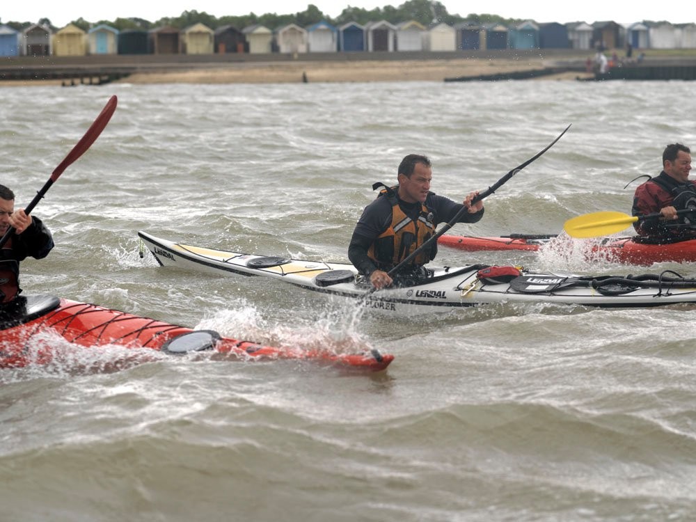 Sea kayakers off the beach in Brightlingsea, Essex.