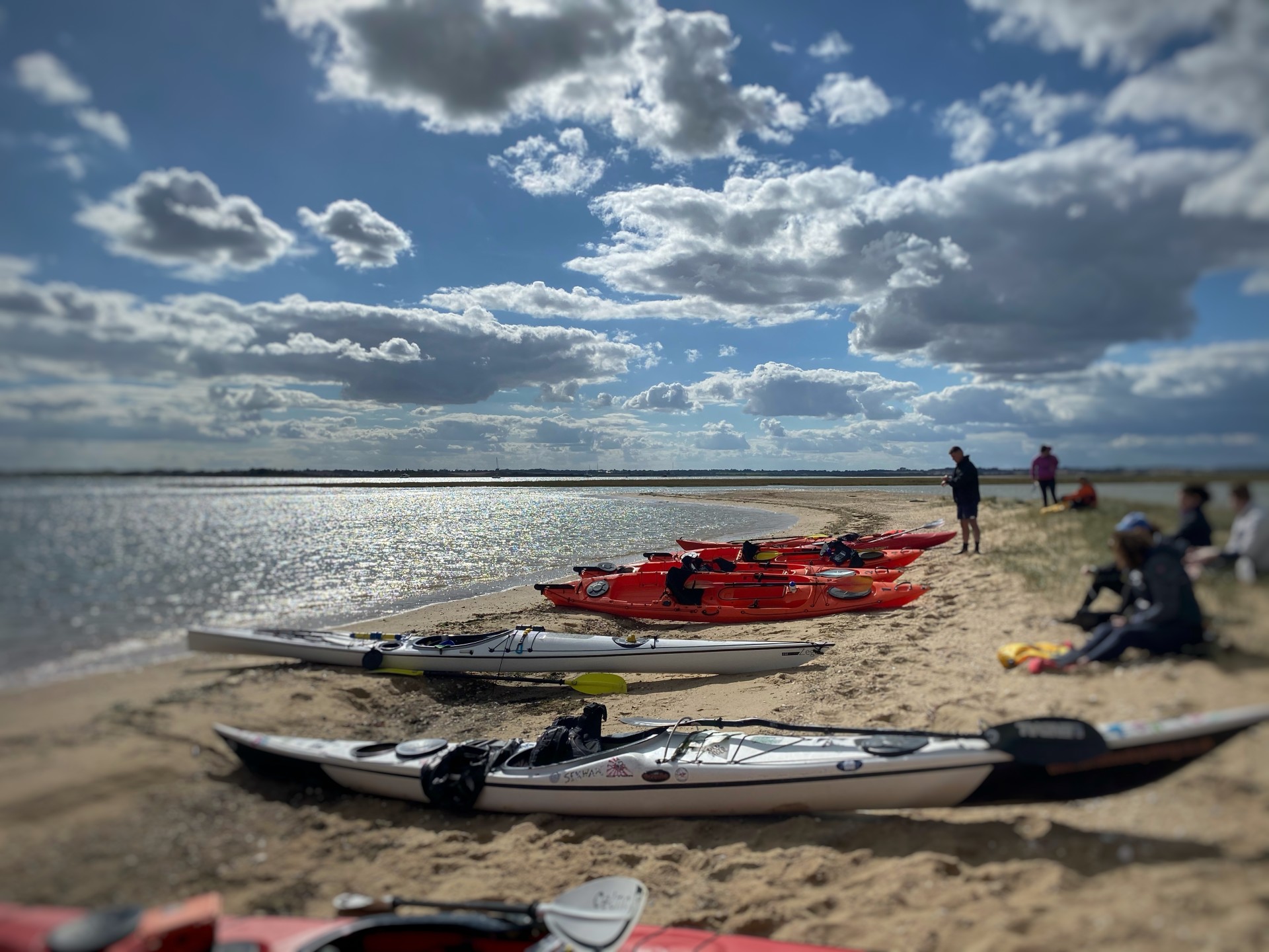 Sea kayaks on a sandy beach on the Seal Colony Eco kayak tour with NOMAD Sea Kayaking.