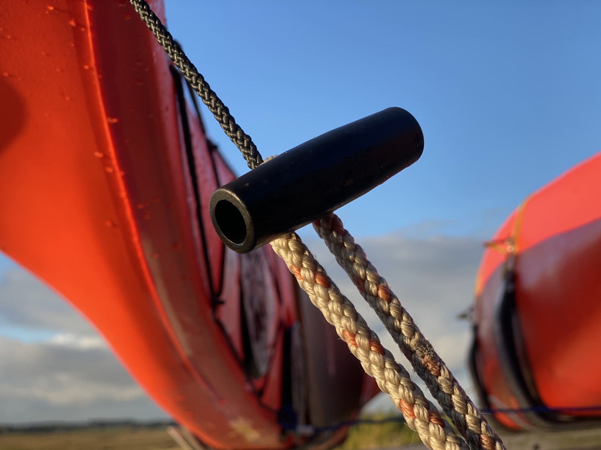 Close up image of an orange sea kayak stern
