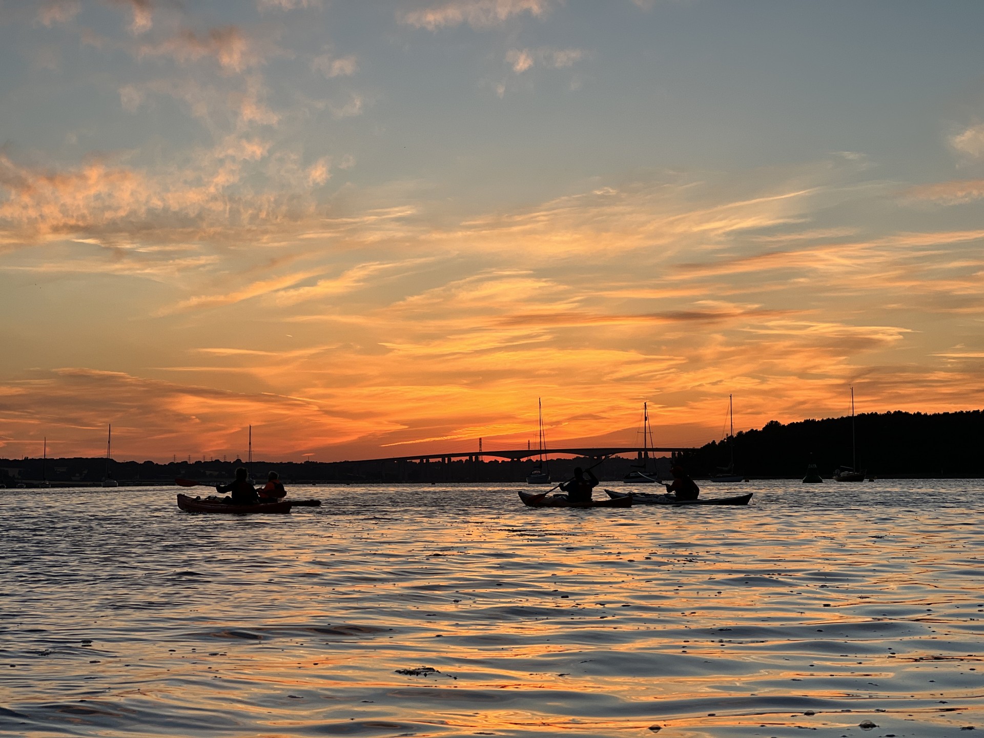 Orwell bridge in the distance with sea kayakers in the foreground.